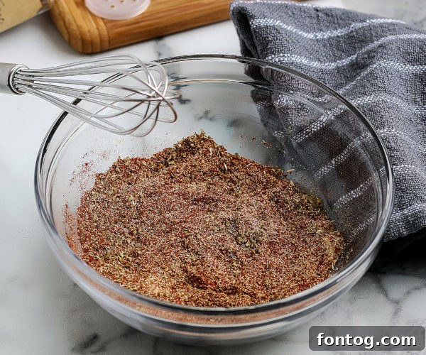 A jar of Homemade Taco Seasoning with a spoon