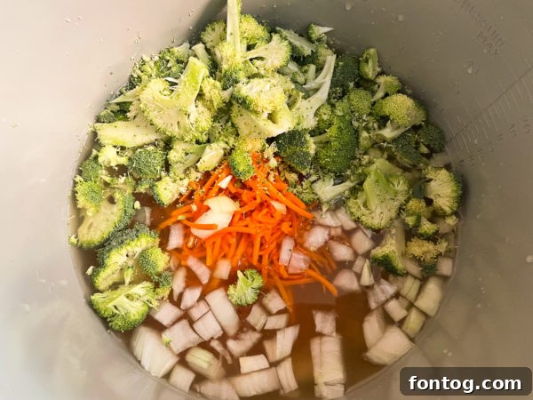 Close-up view of the creamy texture and small broccoli pieces in the Ninja Foodi Broccoli Cheddar Soup.