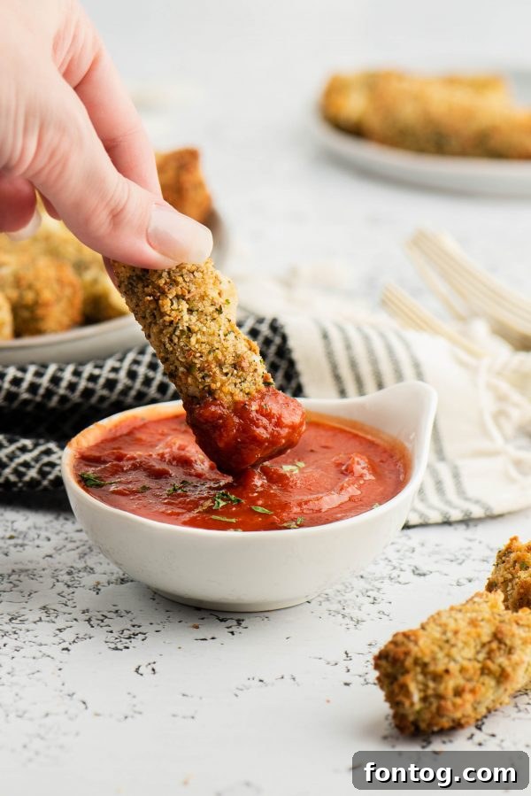 Golden & Gooey: Ninja Foodi Gluten-Free Mozzarella Sticks 7 Freshly air-fried mozzarella sticks arranged on a serving plate.