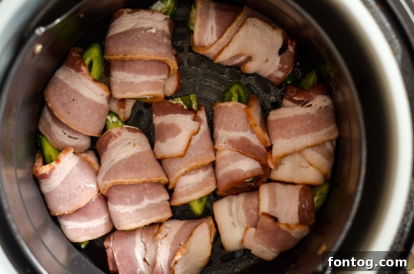 Ninja Foodi preparing stuffed jalapeno peppers