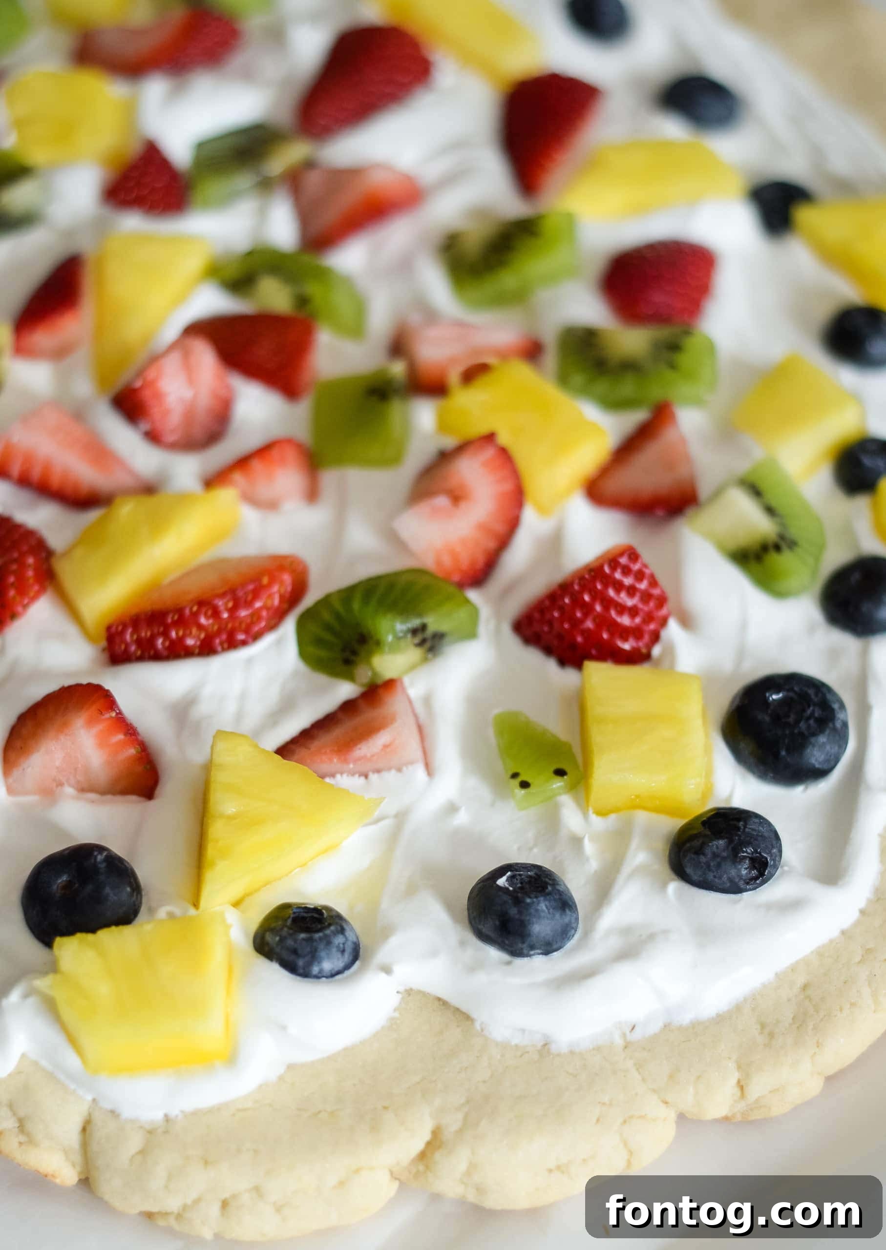A vibrant and fresh easy gluten-free fruit pizza, topped with various fruits.