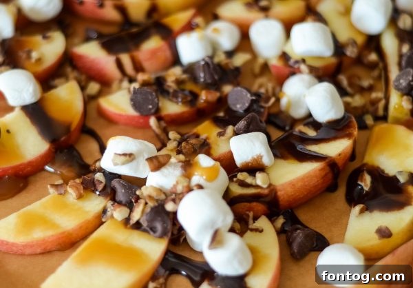 Apple nachos with a variety of sweet toppings, including chocolate and nuts