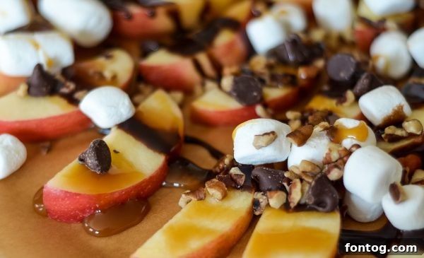 A vibrant close-up of fully topped apple nachos with caramel and chocolate