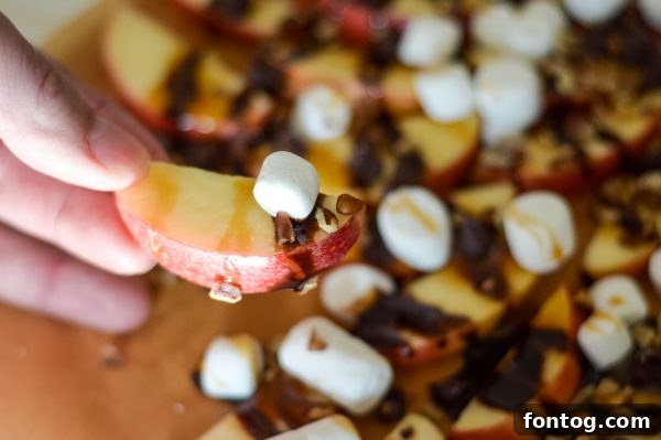 Finished apple nachos on a wooden board, ready to serve