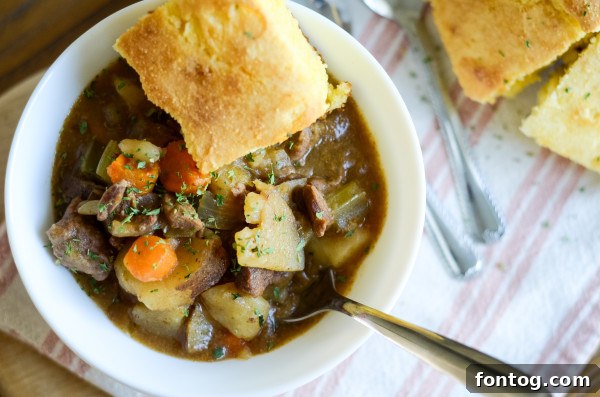 Gluten-Free Slow Cooker Beef Stew in a bowl with cornbread on the side
