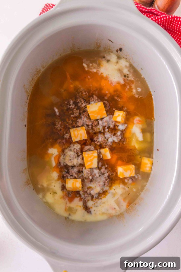 Gluten-Free Slow Cooker Cheeseburger Soup simmering in a slow cooker