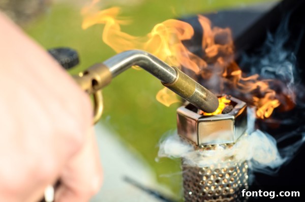 how to smoke cheese on a pellet grill using hard cheese - lighting the smoke tube with a butane torch