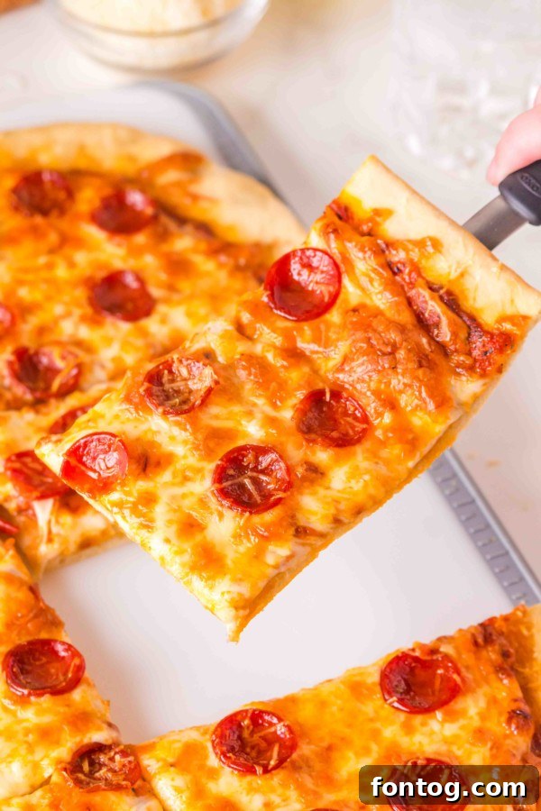Crispy edges of a baked sheet pan pizza.